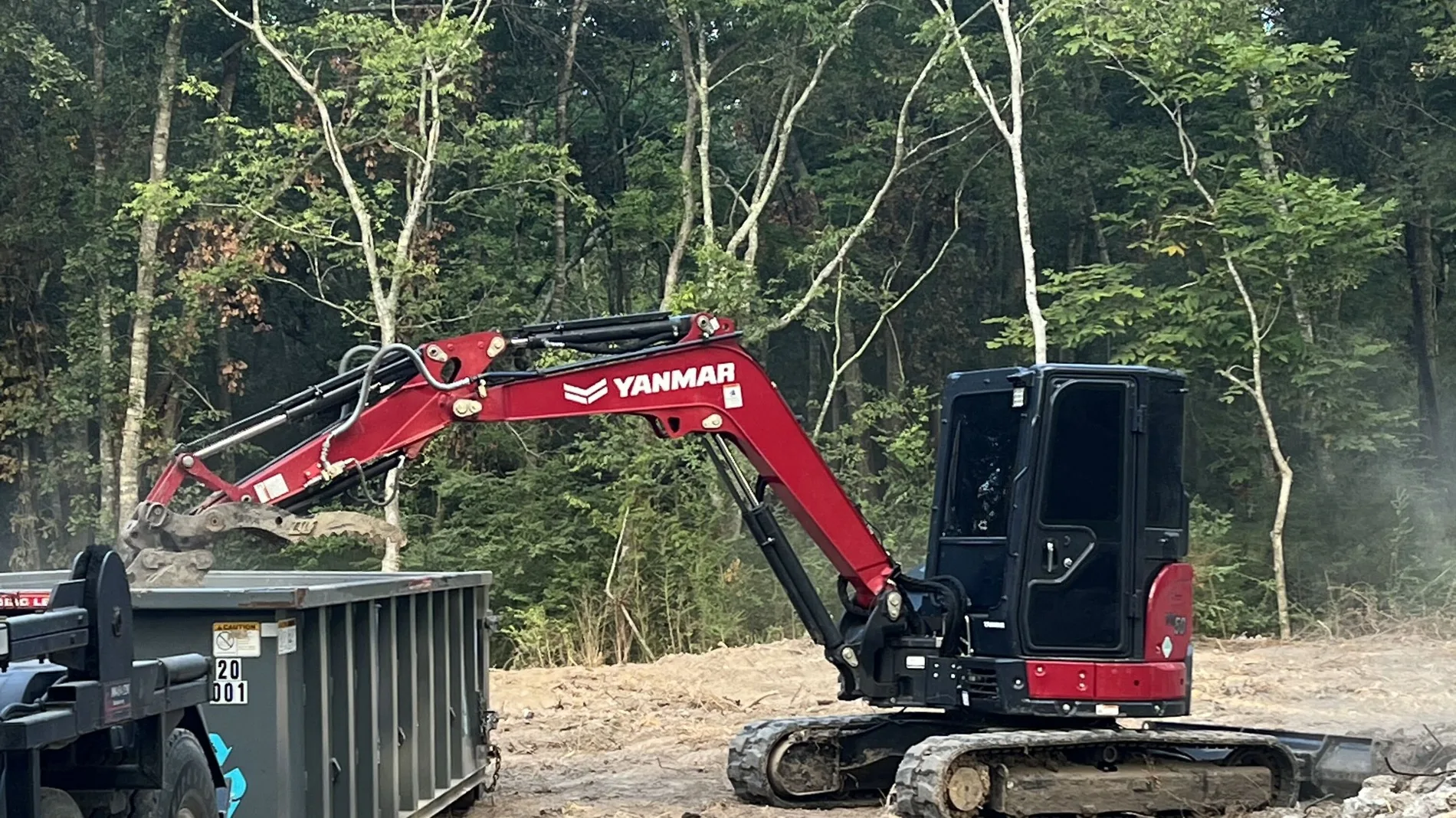 Elite Excavation Services excavator loading demolition debris in New Iberia LA